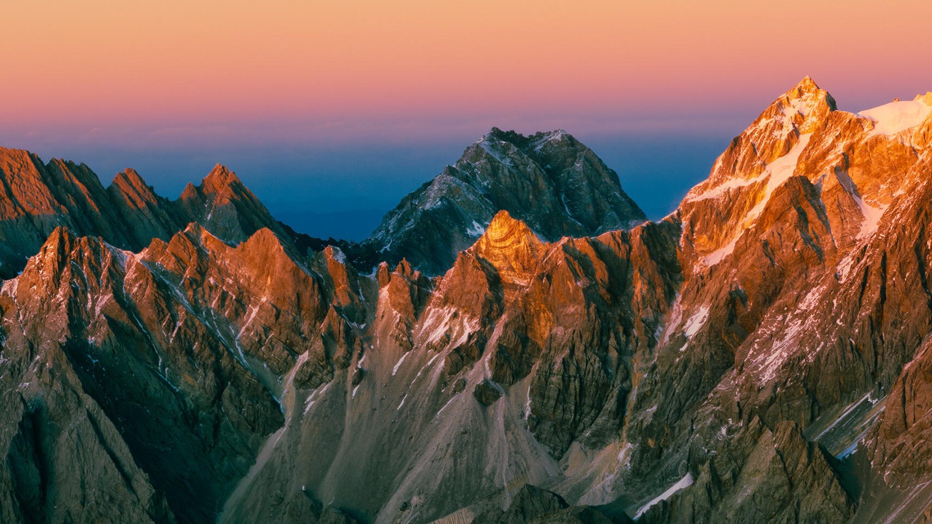 Alpenglow across a high ridgeline at dawn